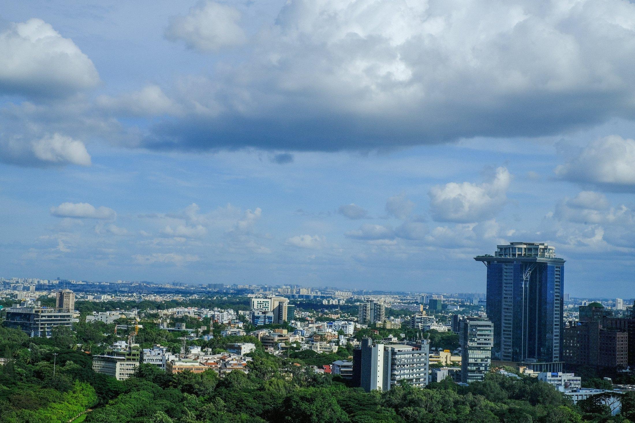 Bengaluru skyline under a cloudy sky.