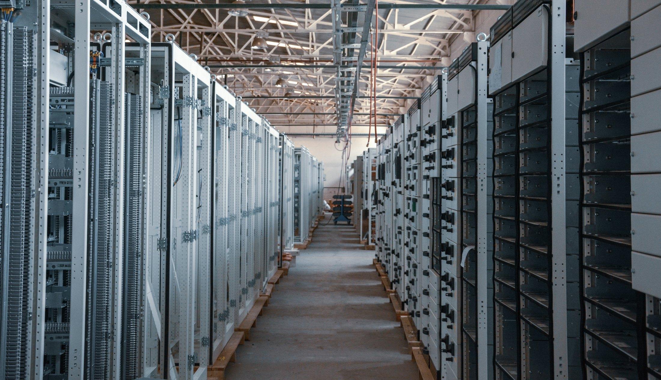 An aisle of server racks in a data centre.
