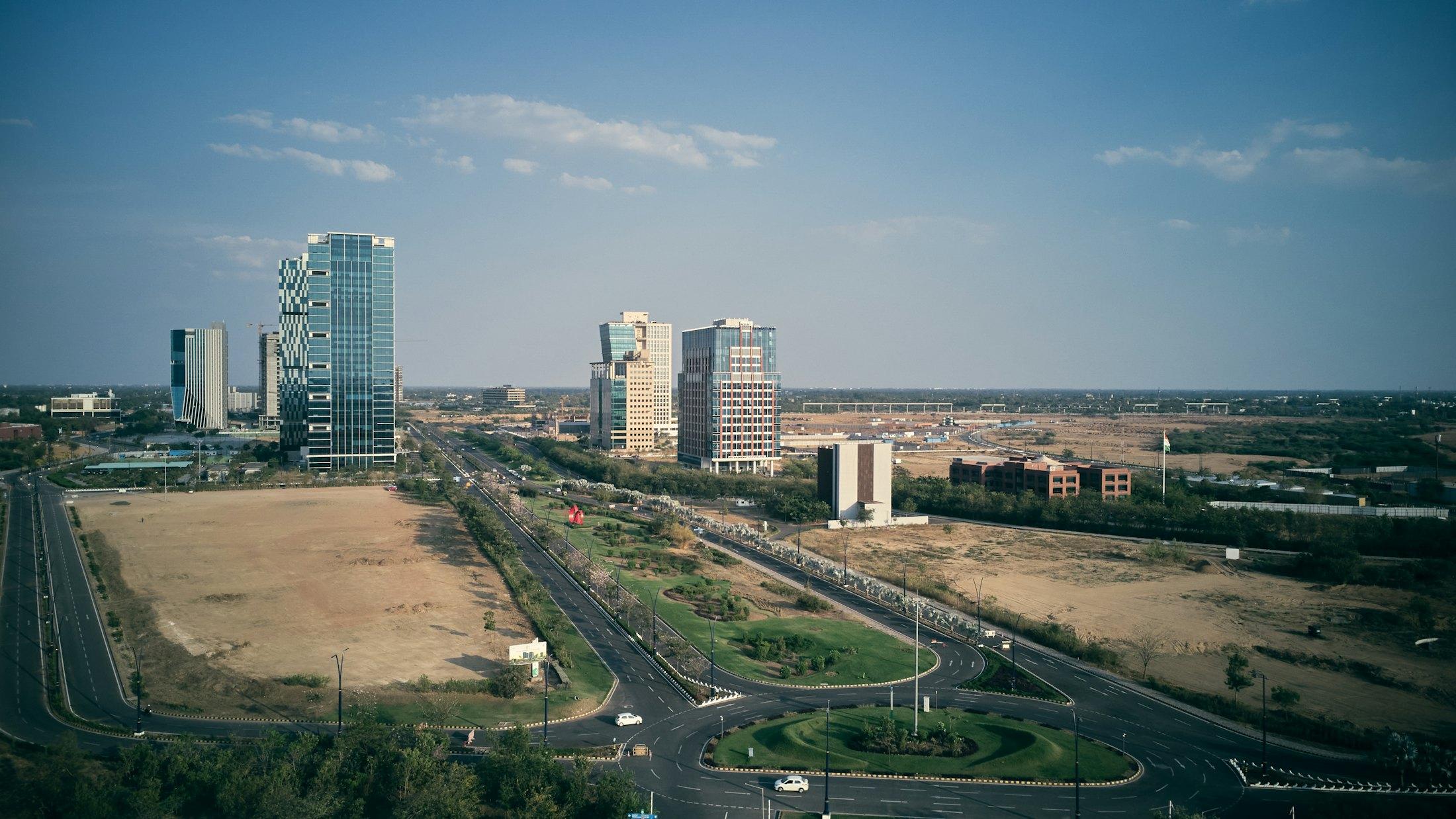 The towers of GIFT City rising from the plain.
